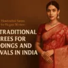 A promotional featured image showing an elegant Indian woman wearing a rich red embroidered traditional saree with gold jewelry, standing against a warm brown background. The design includes a vibrant logo and bold headline text that reads “Best Traditional Sarees for Weddings and Festivals in India,” highlighting classic Indian wedding and festive fashion.